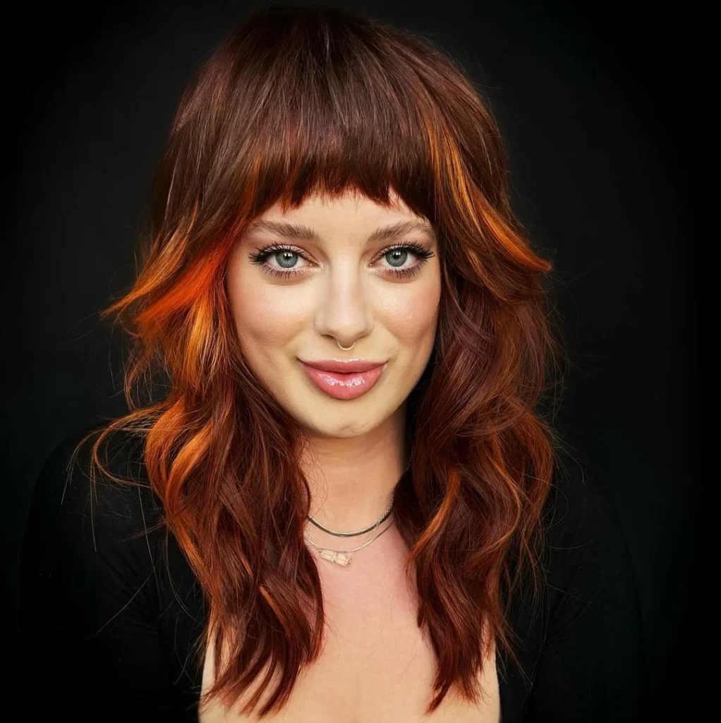 Auburn Shag with Fiery Orange Highlights and Blunt Fringe