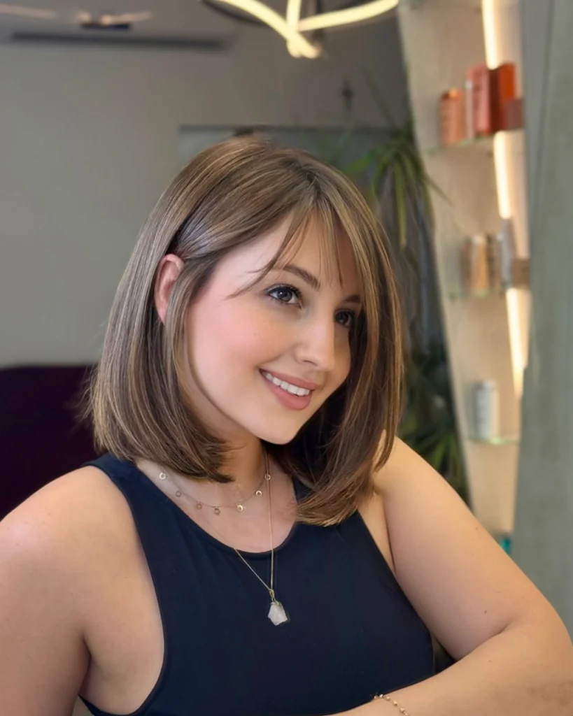 Soft Brown Bob with Side Bangs and Warm Highlights