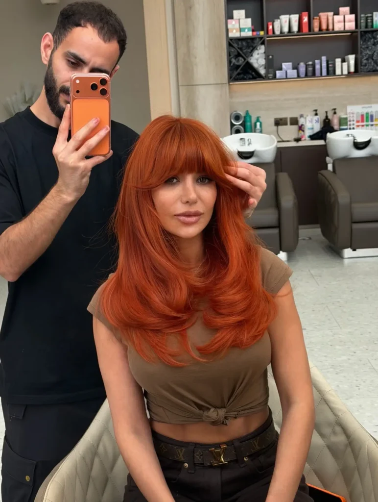 Bold Pumpkin Spice Hair With Full Curtain Bangs